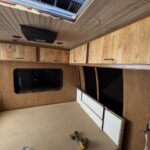 Bed with electric lift mechanism van interior