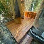 deck behind airstream trailer with shower
