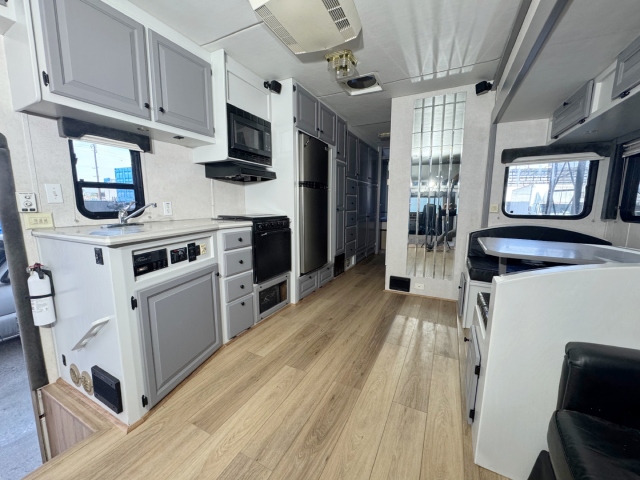 4 Light Gray RV Kitchen, Black Upholstery, and Light Brown Floor